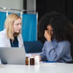 Psych Nurse Practitioner listens to distressed female patient