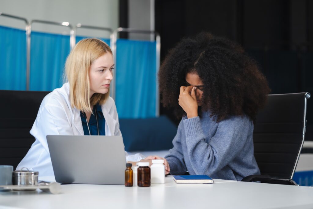 Psych Nurse Practitioner listens to distressed female patient