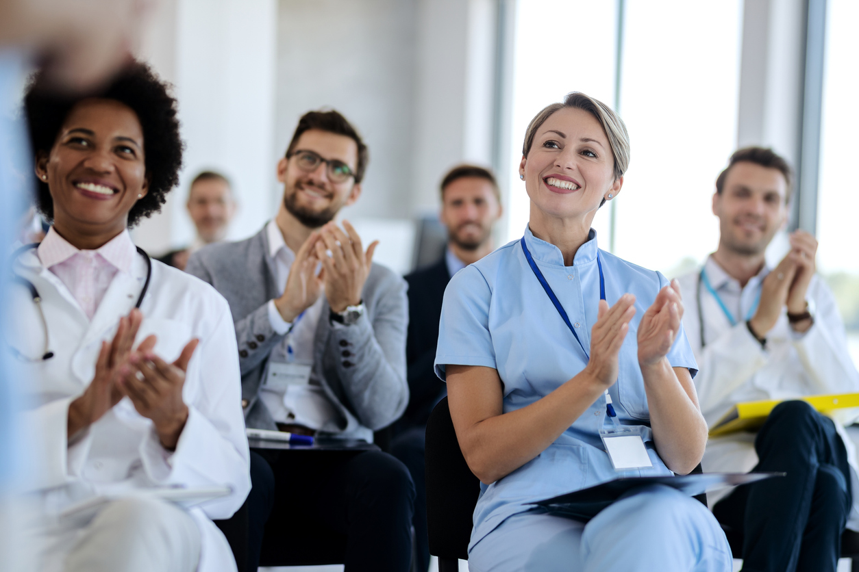 Medical conference attendees clapping