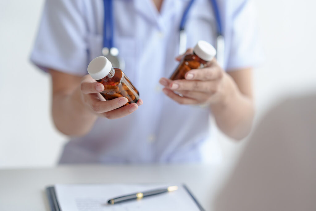 Nurse holding a medicine bottle in each each