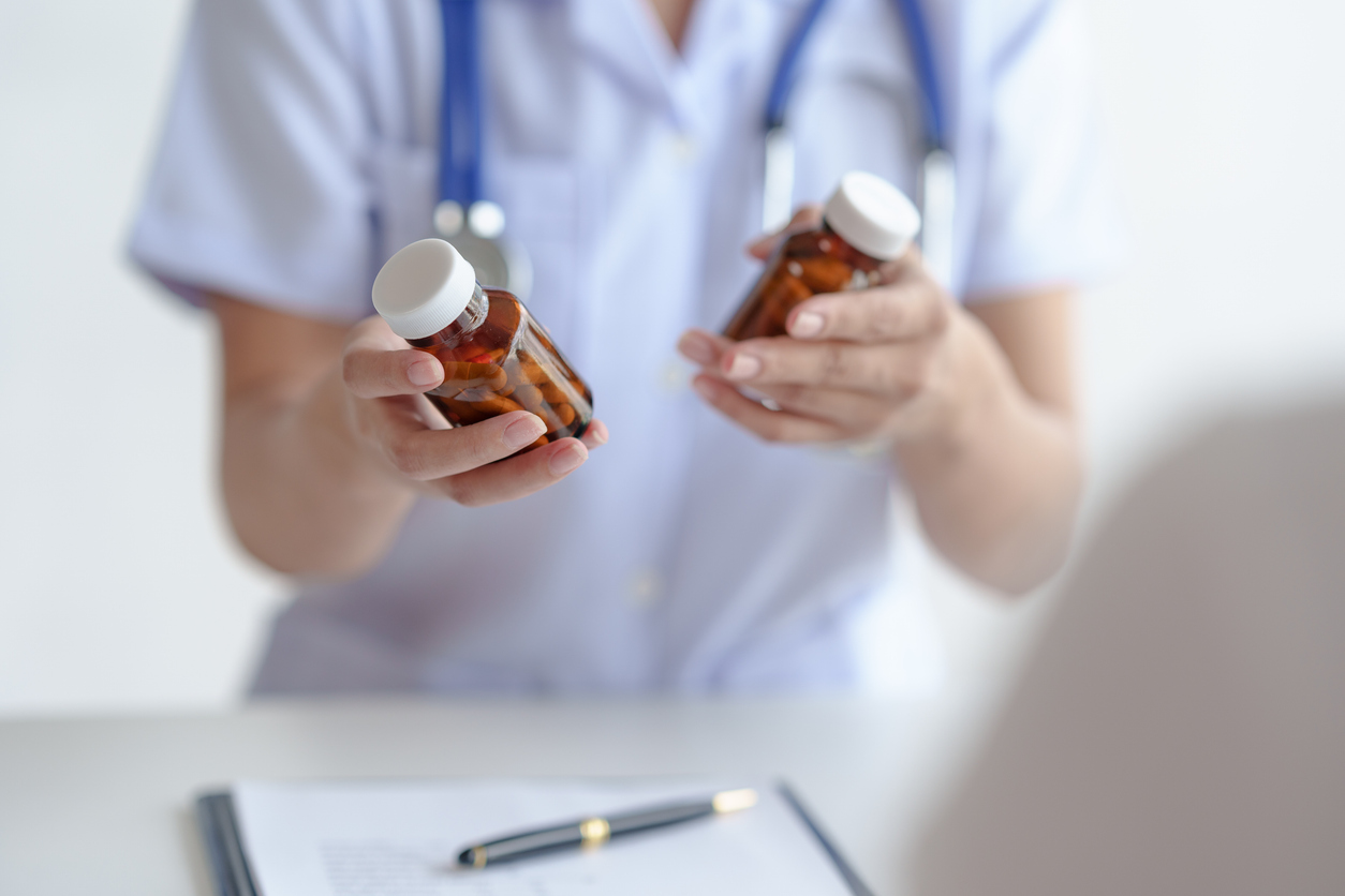 Nurse holding a medicine bottle in each each